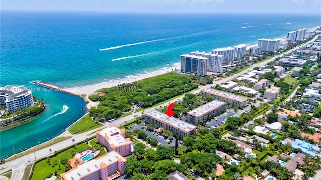 drone / aerial view featuring a beach view and a water view