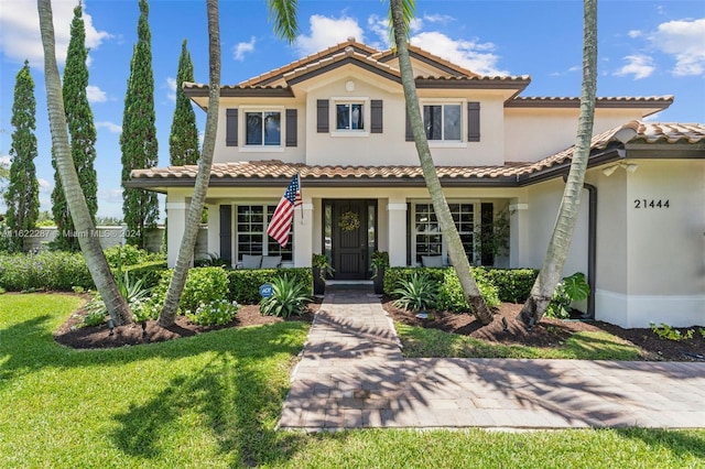 mediterranean / spanish home featuring a front yard