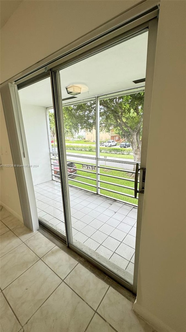 doorway to outside with light tile patterned floors and a wealth of natural light