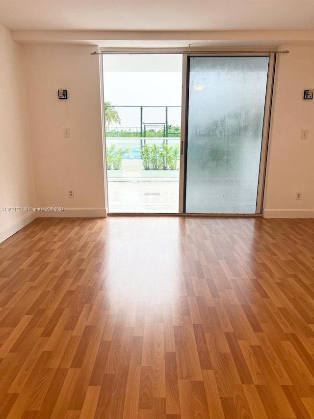 unfurnished room featuring wood-type flooring