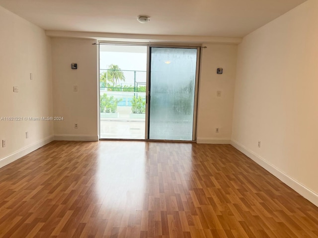 spare room with hardwood / wood-style flooring