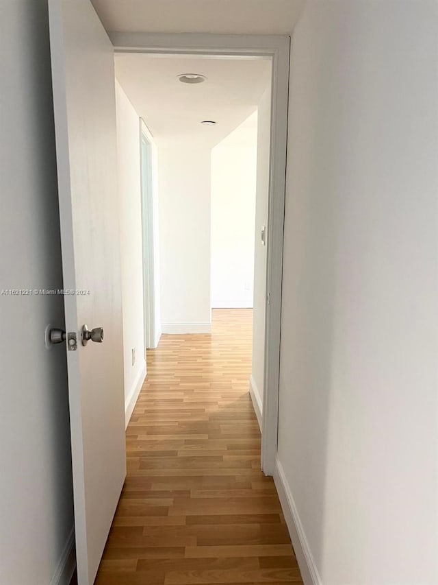 corridor with light hardwood / wood-style flooring