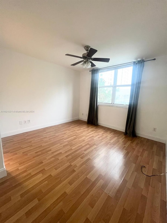 unfurnished room with ceiling fan and light wood-type flooring