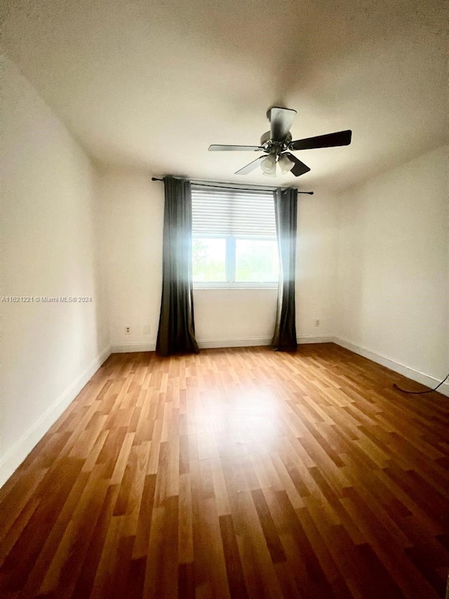 empty room featuring wood-type flooring and ceiling fan