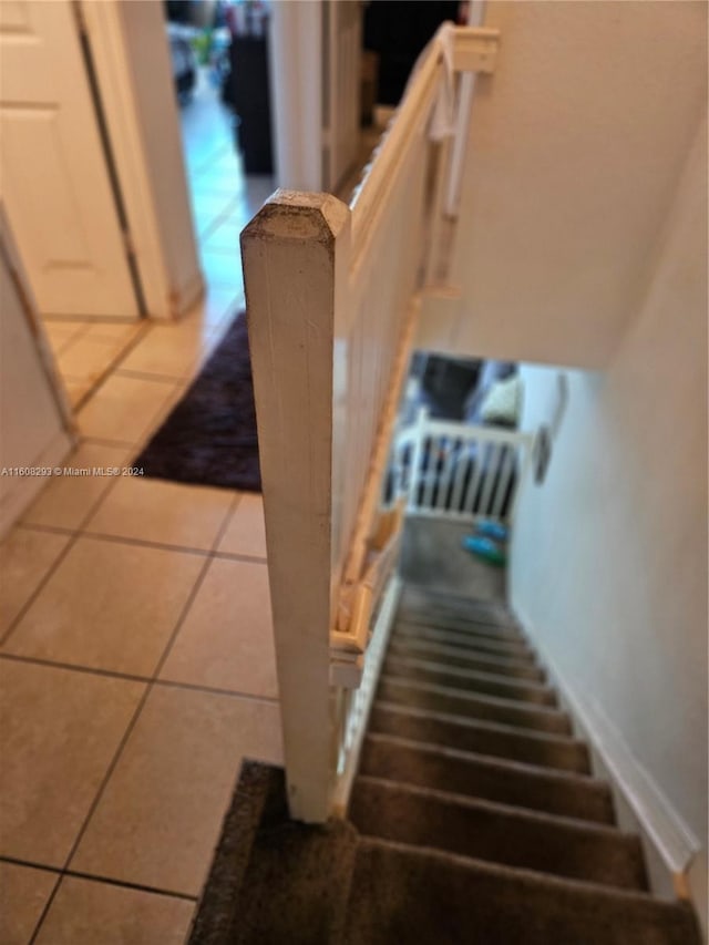 staircase featuring tile patterned flooring