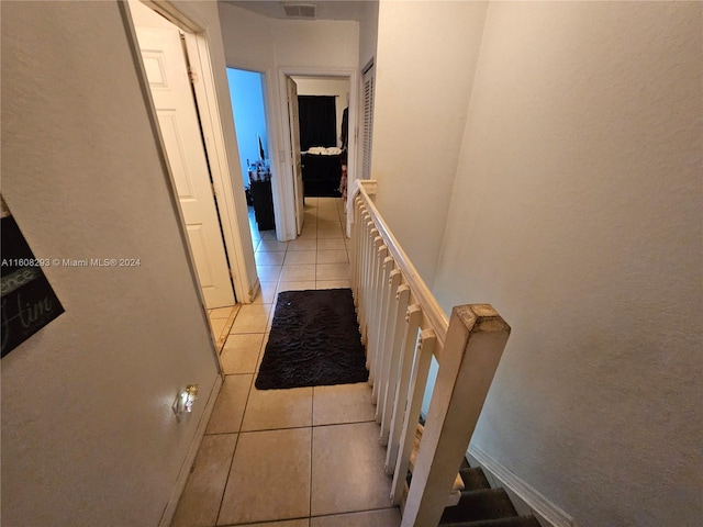 corridor with light tile patterned flooring