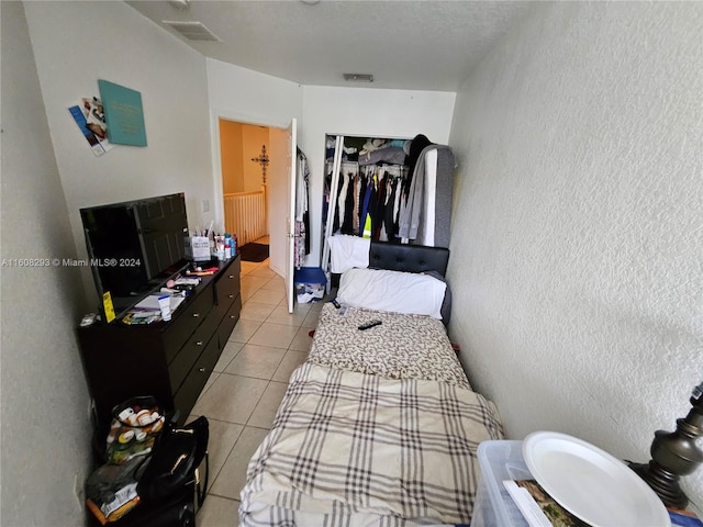 bedroom featuring light tile patterned flooring and a closet