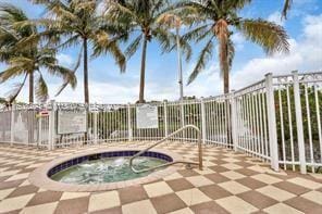 view of swimming pool with a hot tub