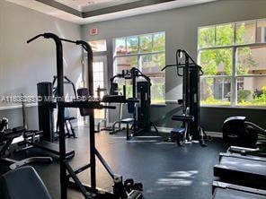 workout area with a raised ceiling