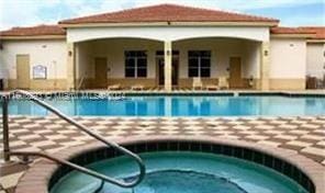 view of pool featuring a hot tub