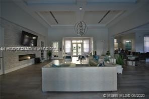 living room with coffered ceiling, wood-type flooring, and french doors