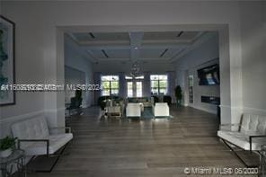 interior space featuring wood-type flooring and coffered ceiling