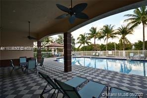 view of pool with ceiling fan and a patio