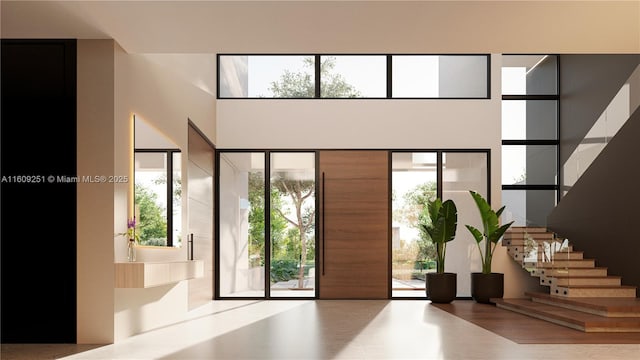 entrance foyer featuring a towering ceiling