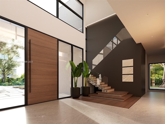 foyer entrance featuring a towering ceiling