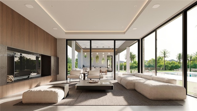 living room with expansive windows, wooden walls, and a raised ceiling