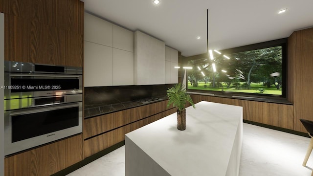 kitchen with white cabinetry, hanging light fixtures, double oven, and dark stone countertops