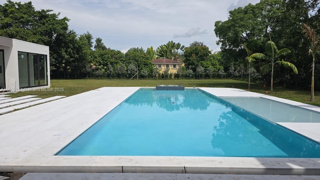 view of swimming pool featuring a yard and a patio area