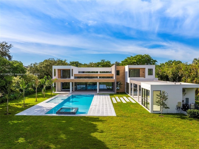 rear view of property featuring a patio and a lawn