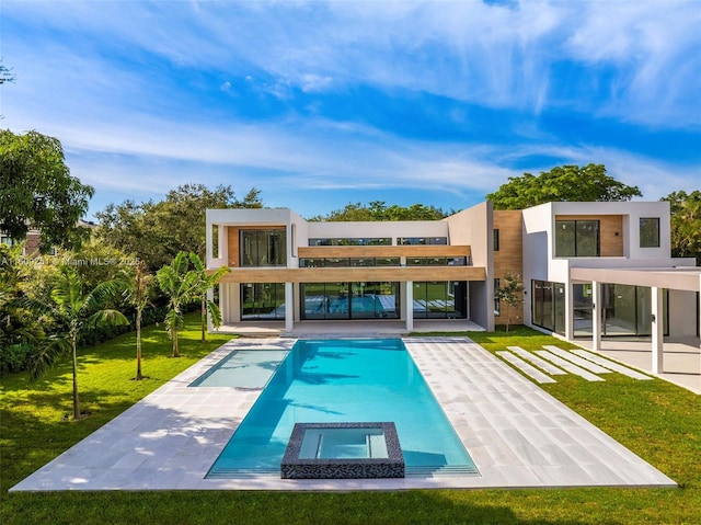 rear view of house with a yard and a patio