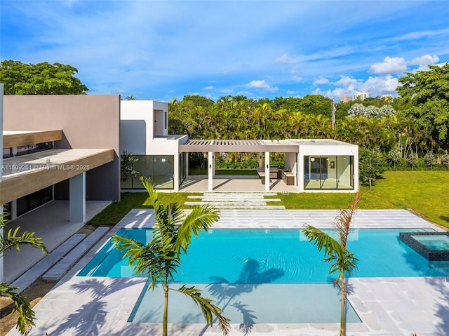 view of swimming pool with a yard, a patio area, and an in ground hot tub