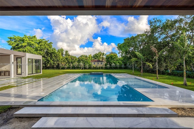 view of pool with a yard and a patio