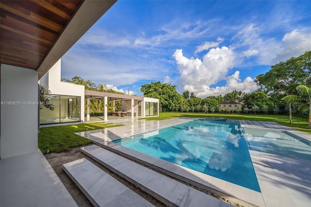 view of swimming pool with a patio and a lawn