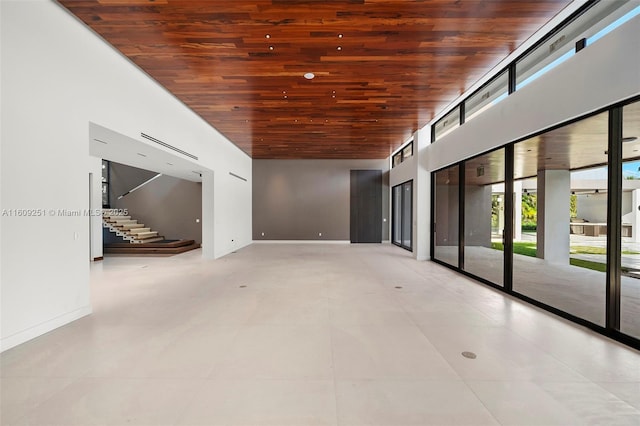 empty room featuring high vaulted ceiling and wood ceiling