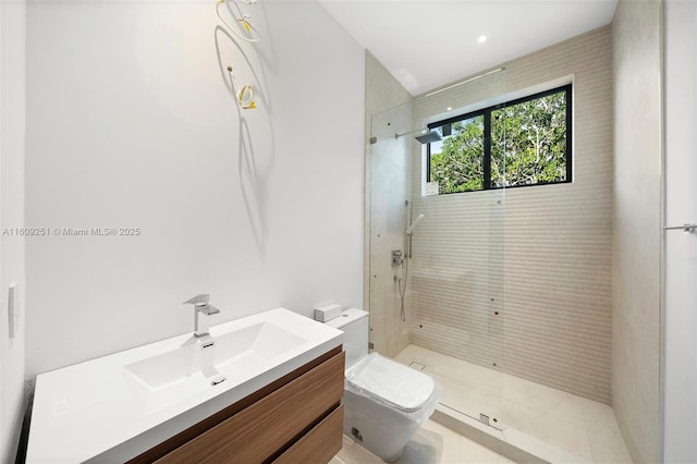 bathroom featuring vanity, toilet, and tiled shower