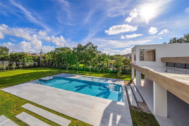 view of pool with a yard and a patio