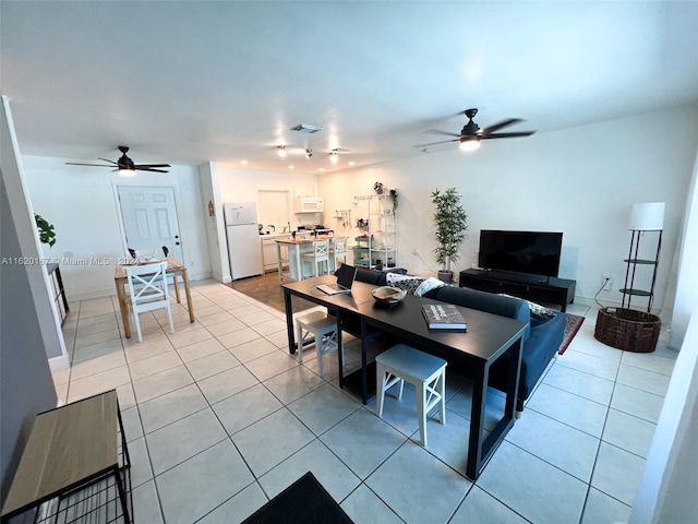 tiled living room featuring ceiling fan