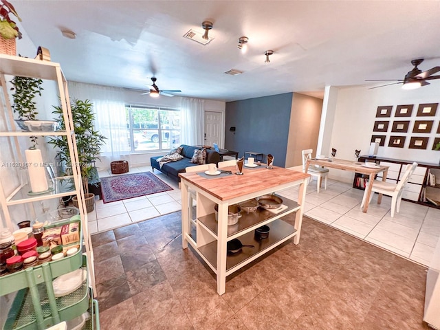 dining space featuring tile patterned floors and ceiling fan