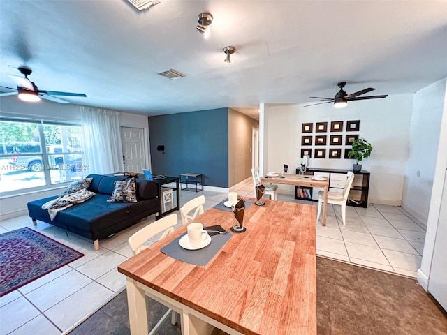 tiled dining room with ceiling fan