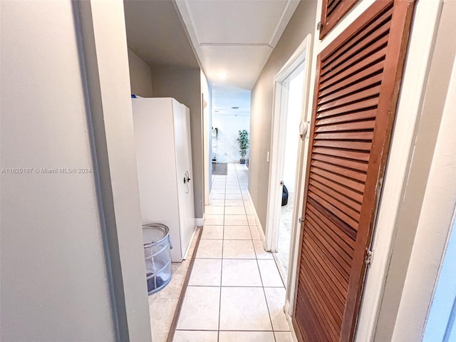 hall featuring light tile patterned floors