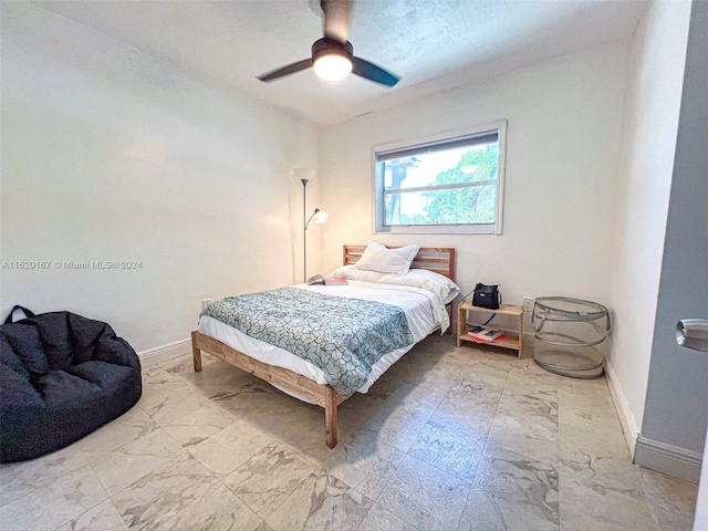 bedroom featuring a textured ceiling and ceiling fan