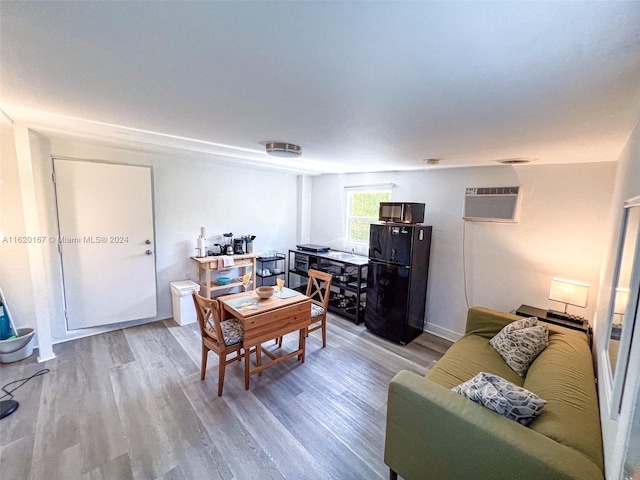 interior space featuring a wall mounted AC and wood-type flooring