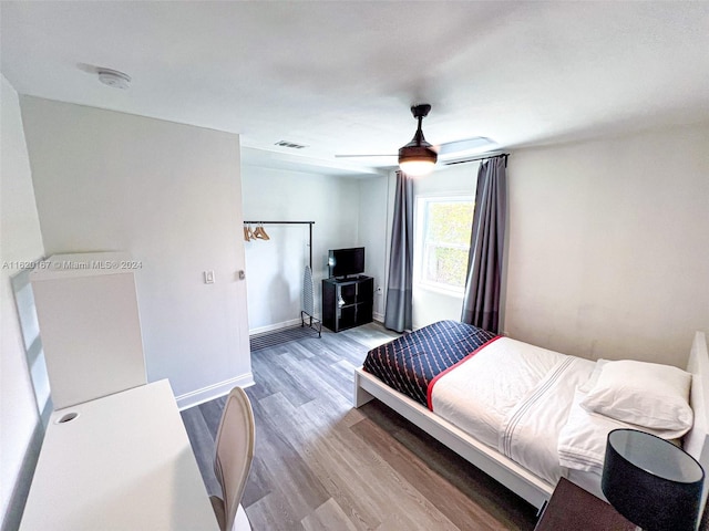 bedroom with ceiling fan and light hardwood / wood-style floors