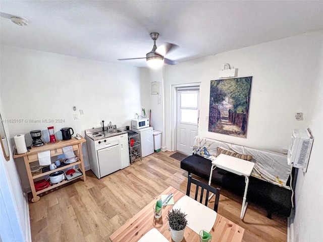 kitchen featuring a wall mounted AC, light wood-type flooring, and ceiling fan