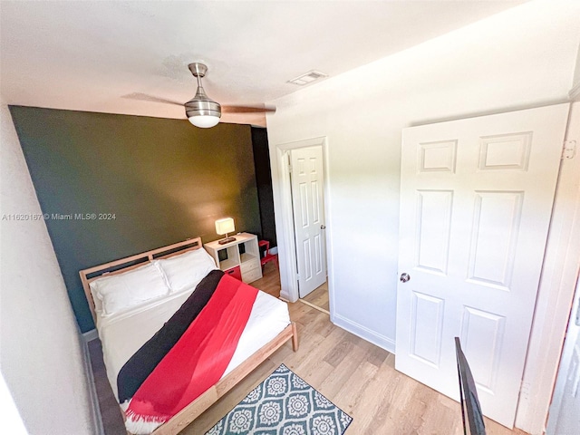 bedroom with ceiling fan and light hardwood / wood-style floors