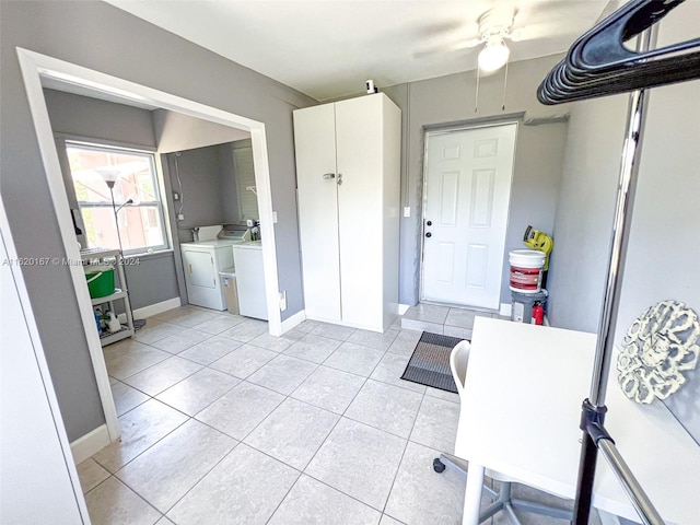 interior space with light tile patterned floors, cabinets, and washing machine and dryer