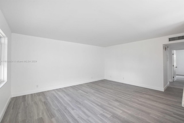 unfurnished room featuring hardwood / wood-style flooring