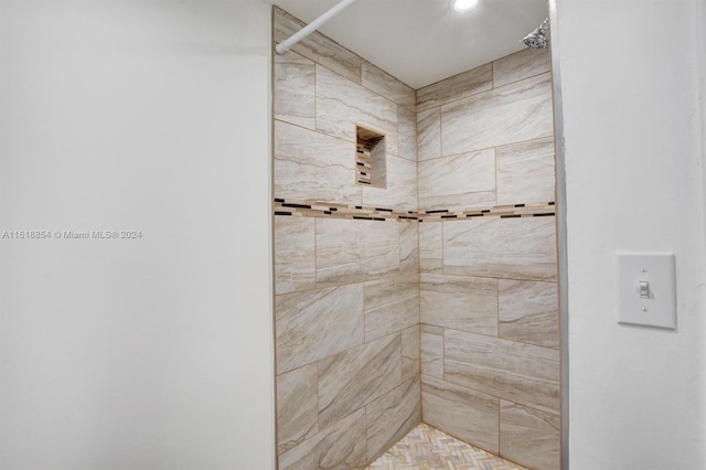 bathroom with a tile shower