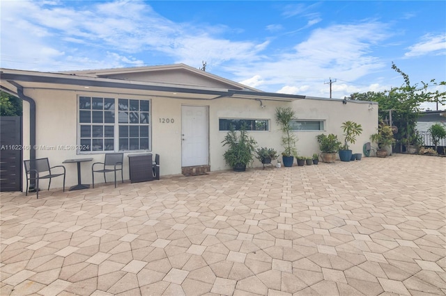 back of house with a patio