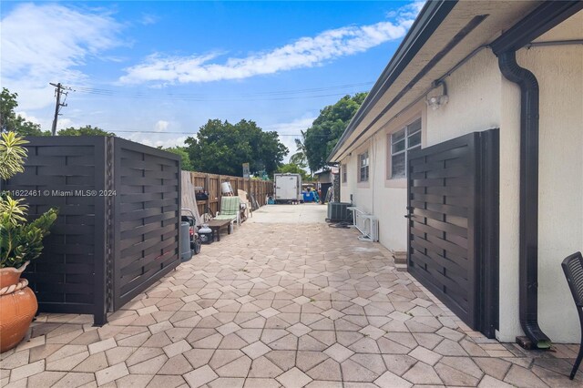 exterior space featuring central air condition unit and a patio