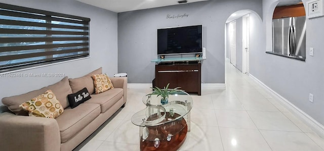 living room with light tile patterned floors and a healthy amount of sunlight