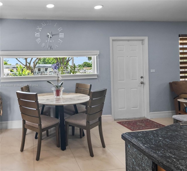 dining space featuring light tile patterned floors