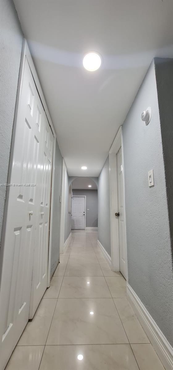 corridor with light tile patterned floors