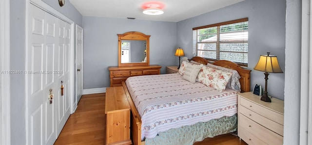 bedroom featuring light hardwood / wood-style flooring and a closet