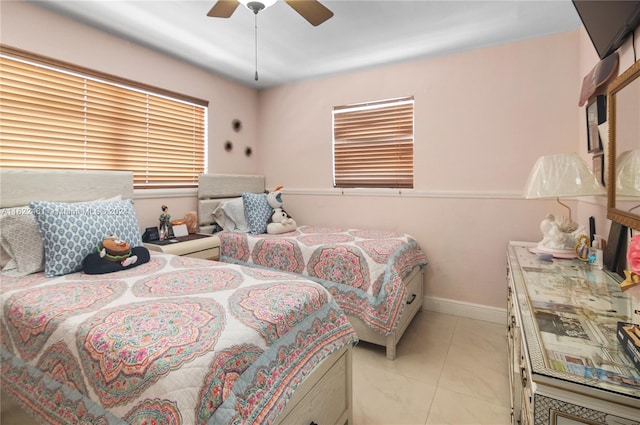 tiled bedroom featuring ceiling fan