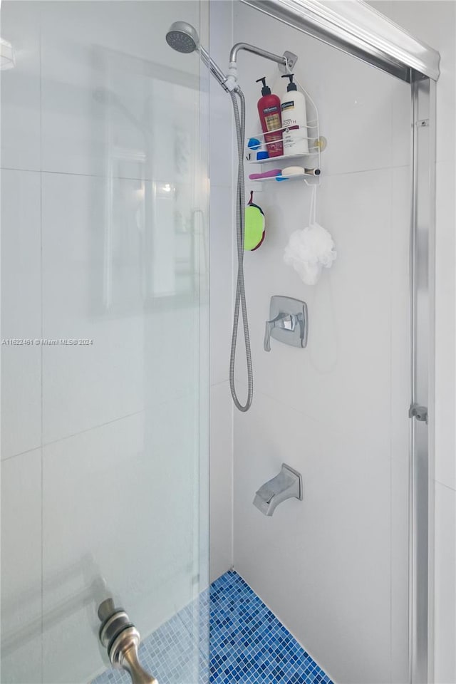 bathroom featuring a shower with door